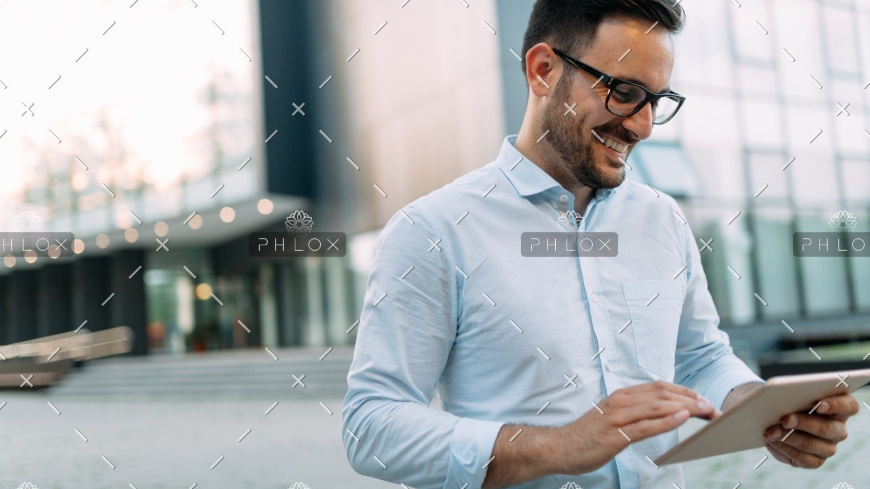 demo-attachment-508-portrait-of-businessman-in-glasses-holding-tablet-AWVHCJU